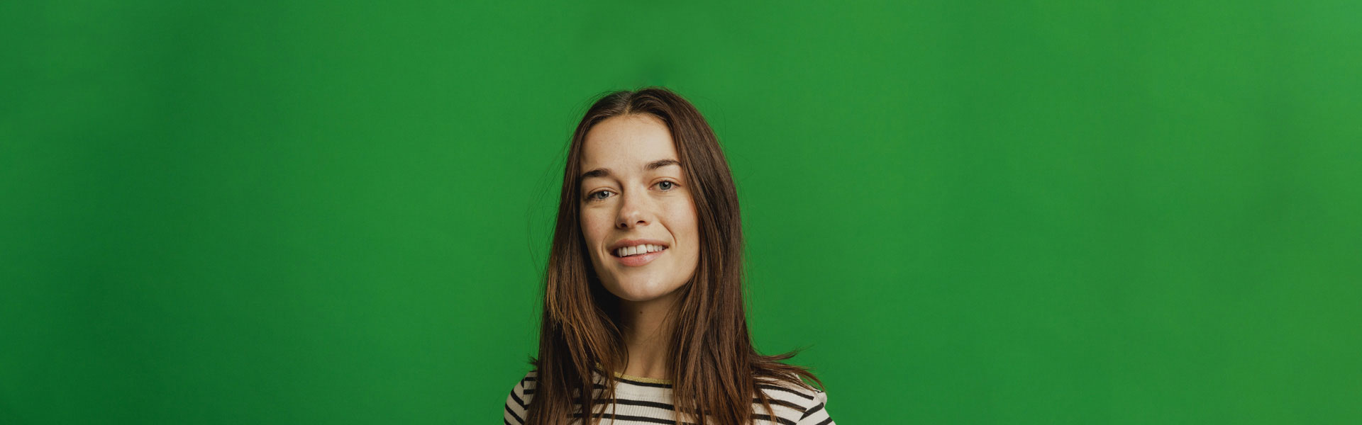 A young employee and member of Creative Pension Trust smiles at the camera